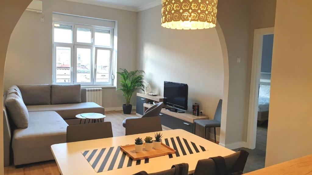 a living room with a couch and a table at City Break Apartments - City Zen in Belgrade