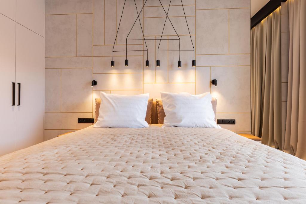 a bedroom with a large bed with two pillows at Baltic Apartments Seaside Towers in Gdańsk