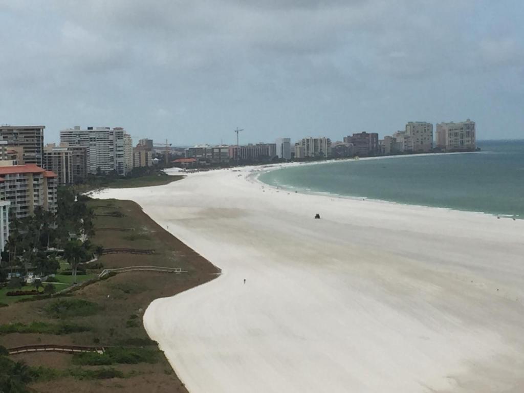 a view of a beach with buildings and the ocean at Beachfront 2 Bed 2 Bath Penthouse Condo in Marco Island