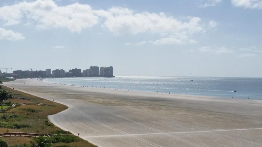 a view of a beach with buildings in the background at South Seas Tower 3 #1009 - Stunning 2/2 Beachfront Condo w/Endless Beach View in Marco Island