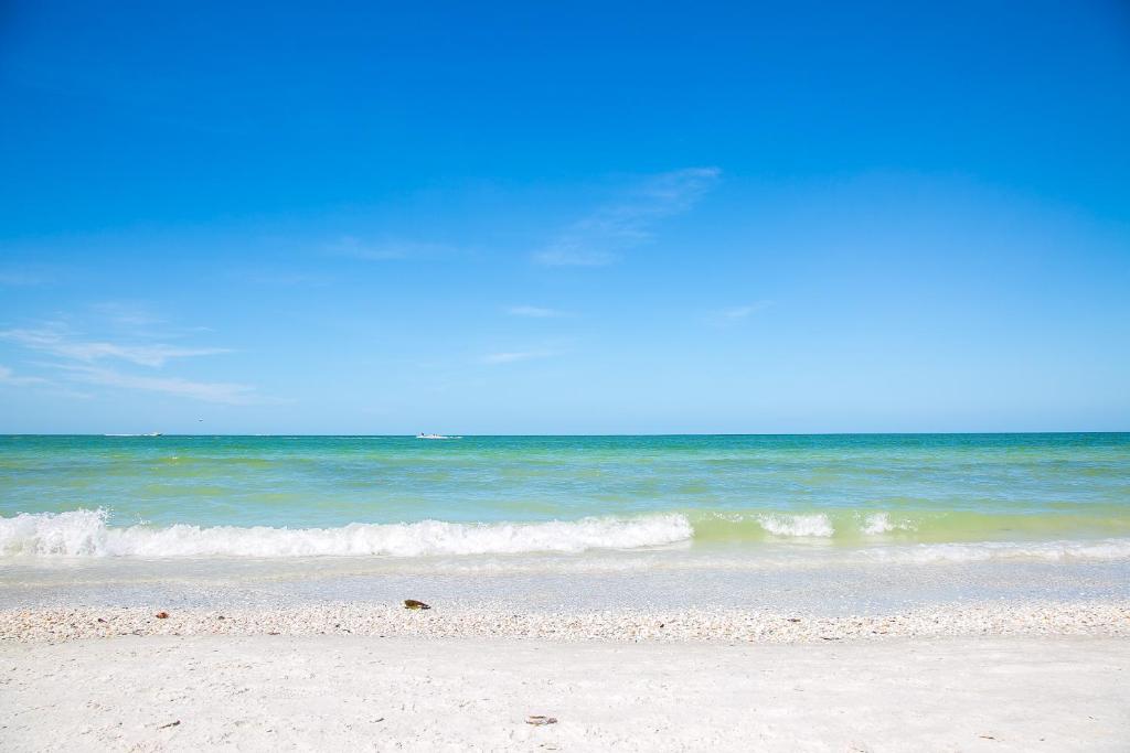 a sandy beach with the ocean in the background at Ideal for Conference @ J.W. Marriott / Access to Beach!! in Marco Island