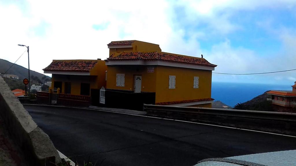 a yellow house on the side of a road at CASA LALI in Alojera