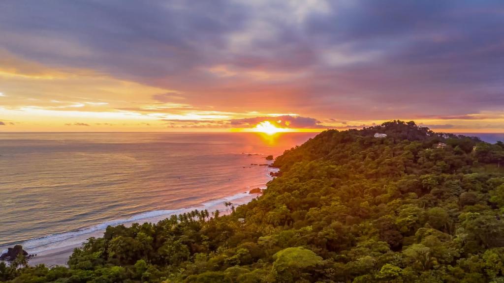 an aerial view of a beach at sunset at Si Como No Resort & Wildlife Refuge in Manuel Antonio