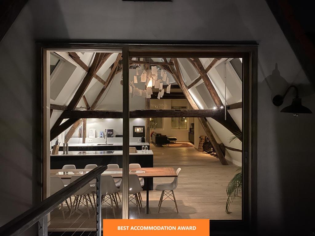 a kitchen with a table and chairs in it at Burgstraat 17 Apartment in Exclusive Patrician House in Medieval Ghent in Ghent