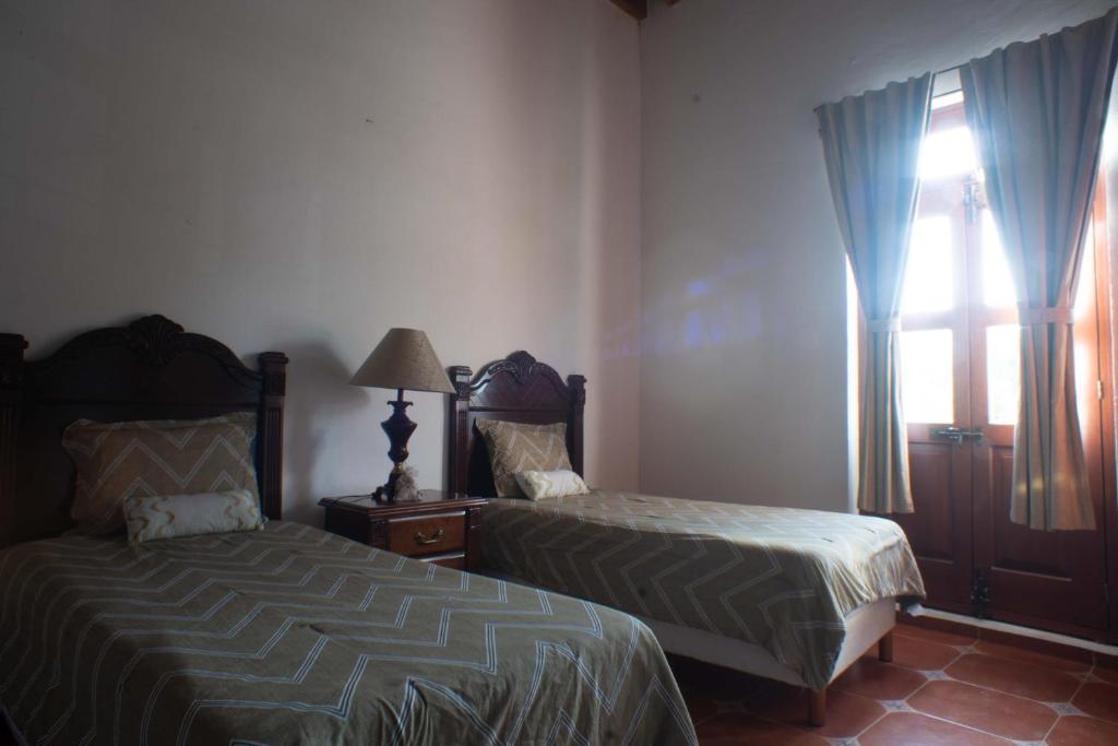 Postel nebo postele na pokoji v ubytování HOTEL ECOTURISTICO LA SALITRERA