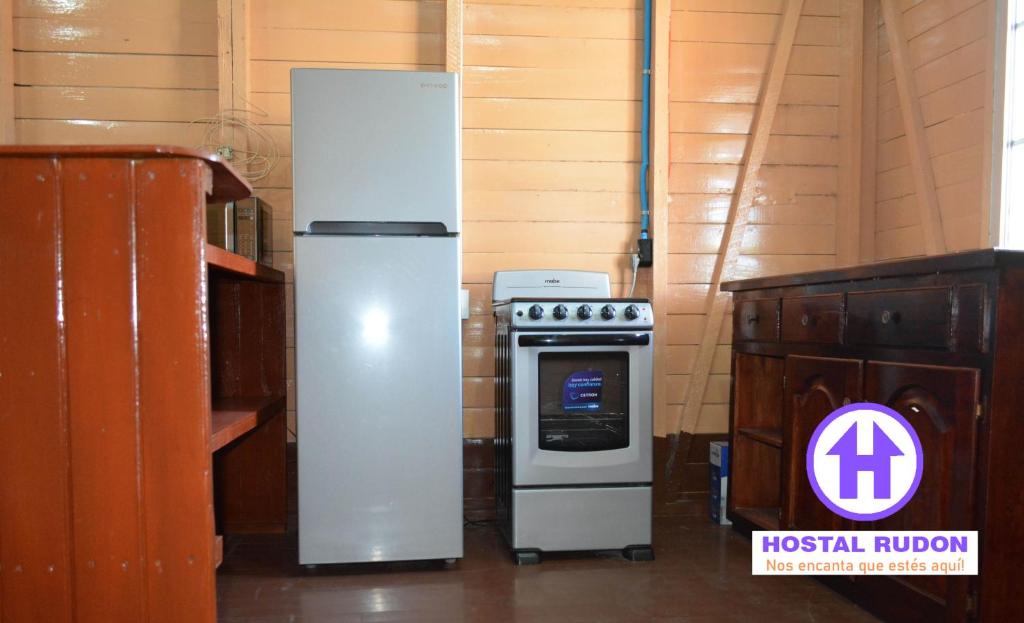 a refrigerator next to a stove in a room at Apartamentos y Hostal RUDON #1 in Puerto Cortés
