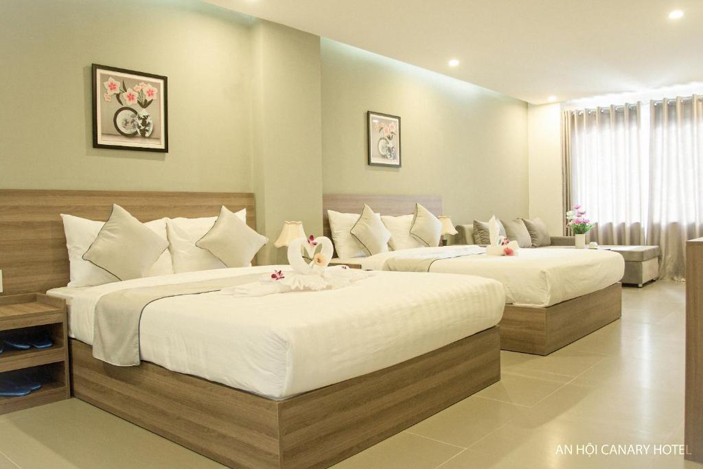 Postel nebo postele na pokoji v ubytování An Hoi Canary Hotel