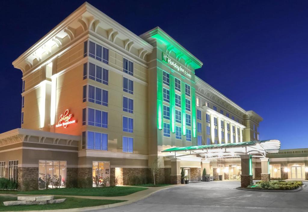 a large building with a clock on the front of it at Holiday Inn and Suites East Peoria, an IHG Hotel in Peoria
