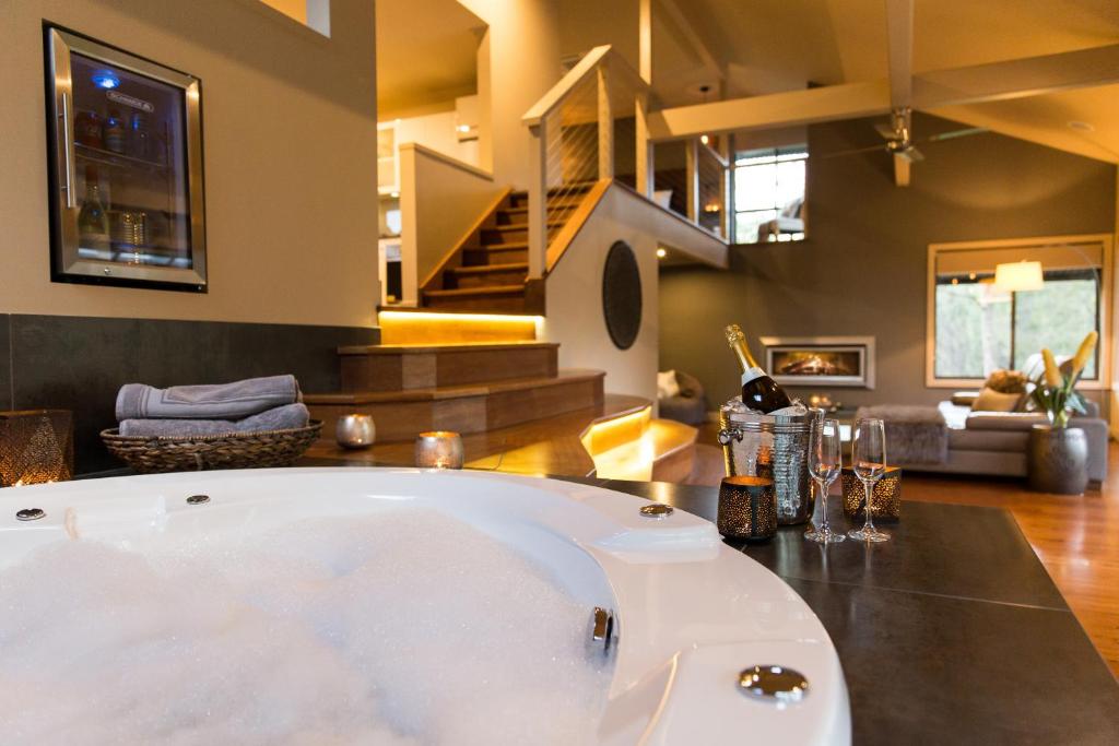 a bath tub in the middle of a living room at The Edge Villa in Mount View