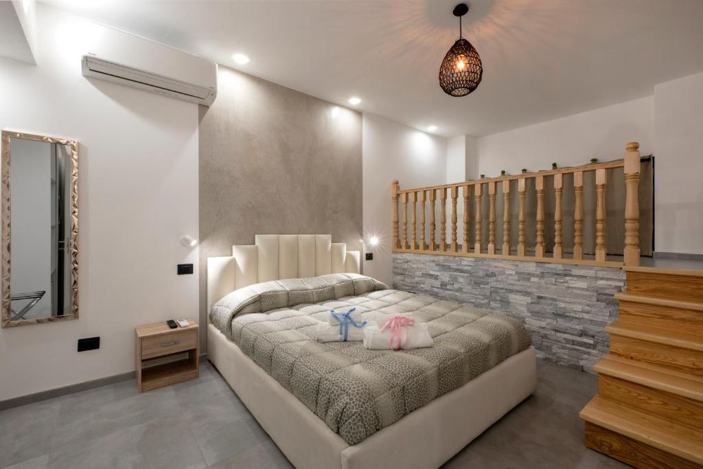 a bedroom with a bed with two shoes on it at SABRILUNA ROOMS in La Spezia