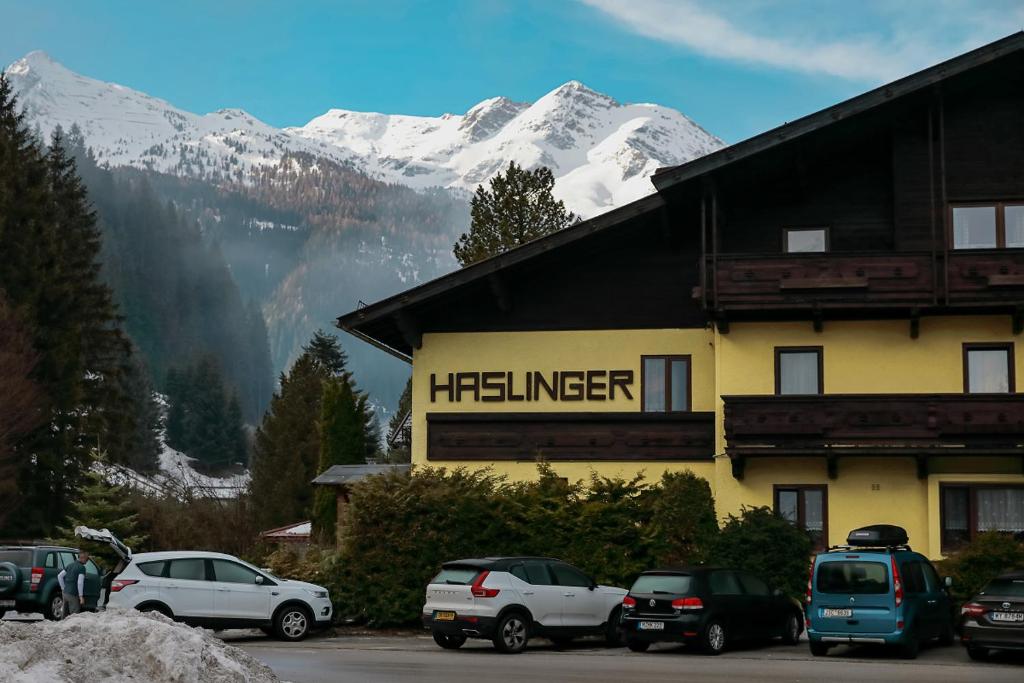 a hotel with cars parked in front of a building at Alpenpension Haslinger in Bad Gastein