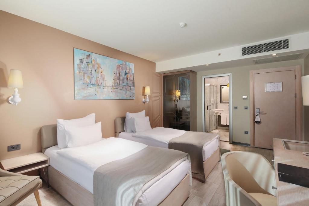 A bed or beds in a room at The Gate Ataşehir Finance Centre