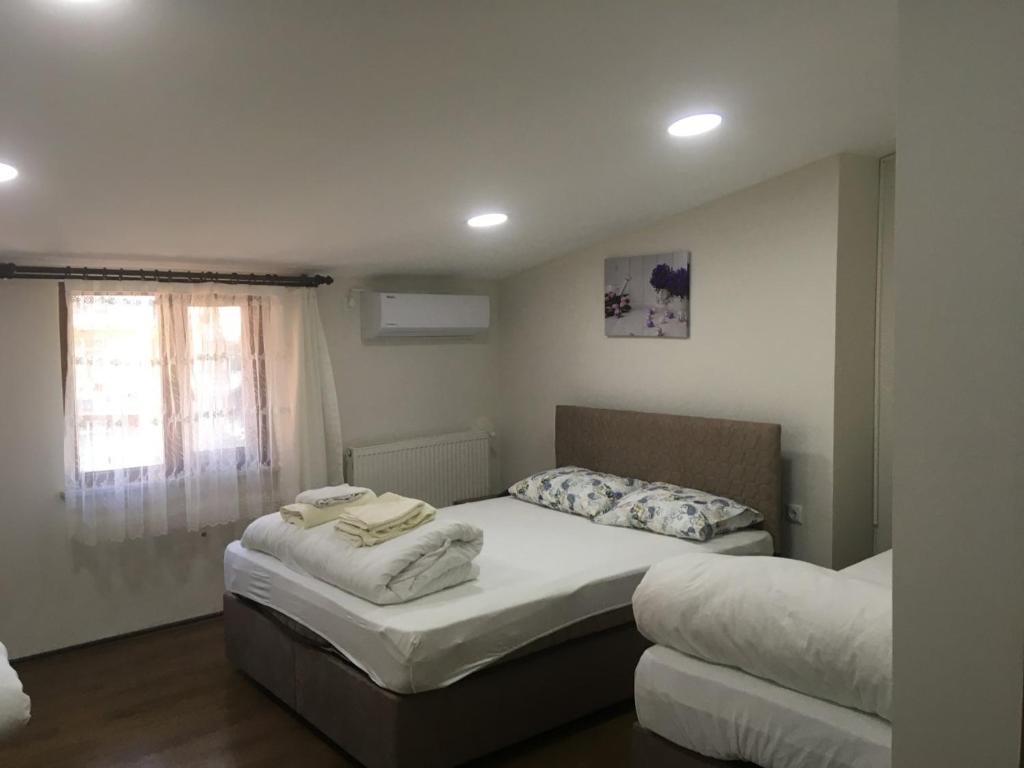a bedroom with two beds and a window at Kule Hotel in Bursa