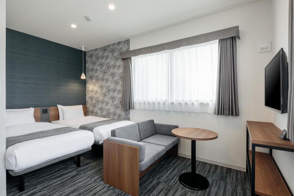 Postel nebo postele na pokoji v ubytování M's Hotel Nijojo Oike