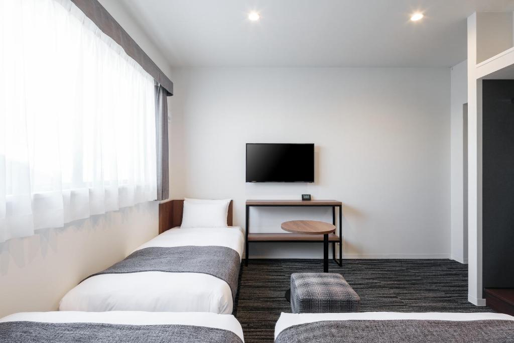 Postel nebo postele na pokoji v ubytování M's Hotel Nijojo Oike