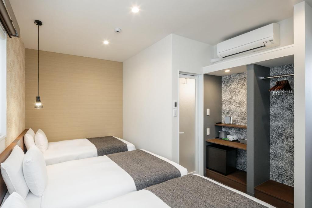 Postel nebo postele na pokoji v ubytování M's Hotel Nijojo Oike
