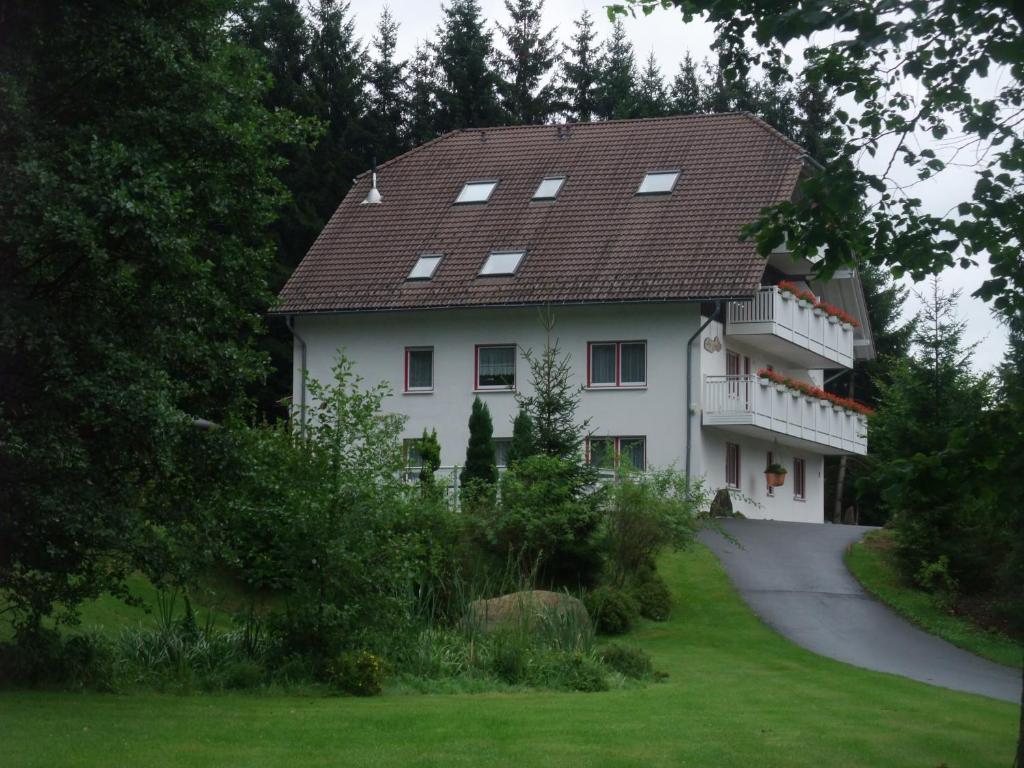 a large white house with a brown roof at Ferienhaus Hubertus in Elend mit Balkons in Elend