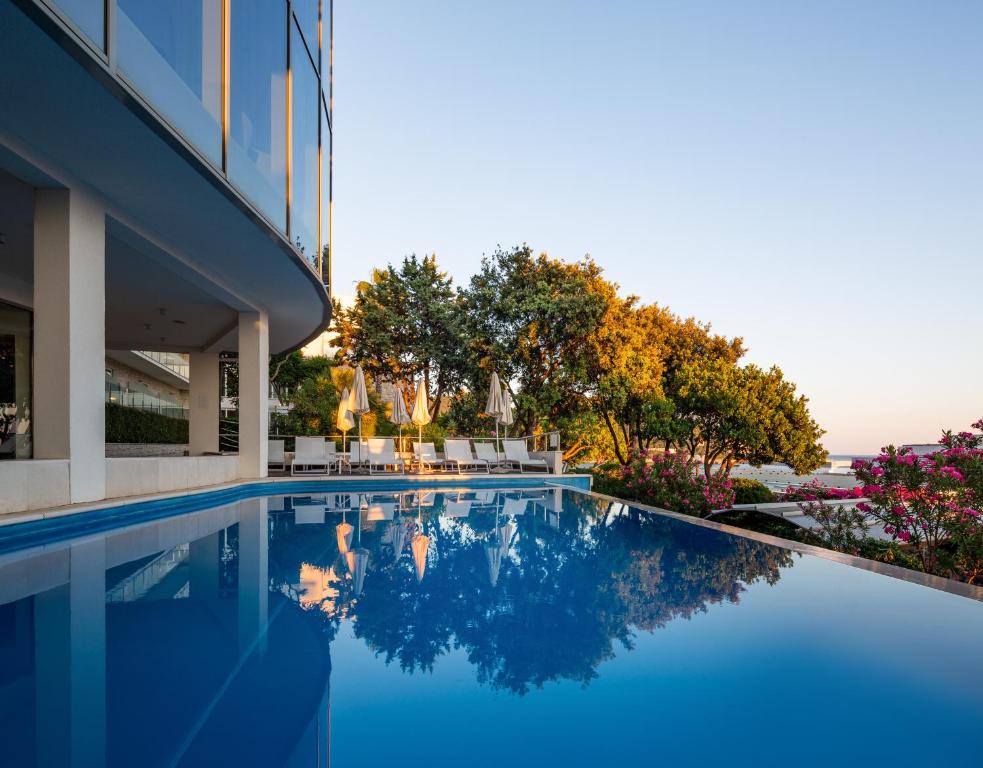 a swimming pool in front of a building at Royal Neptun Hotel in Dubrovnik