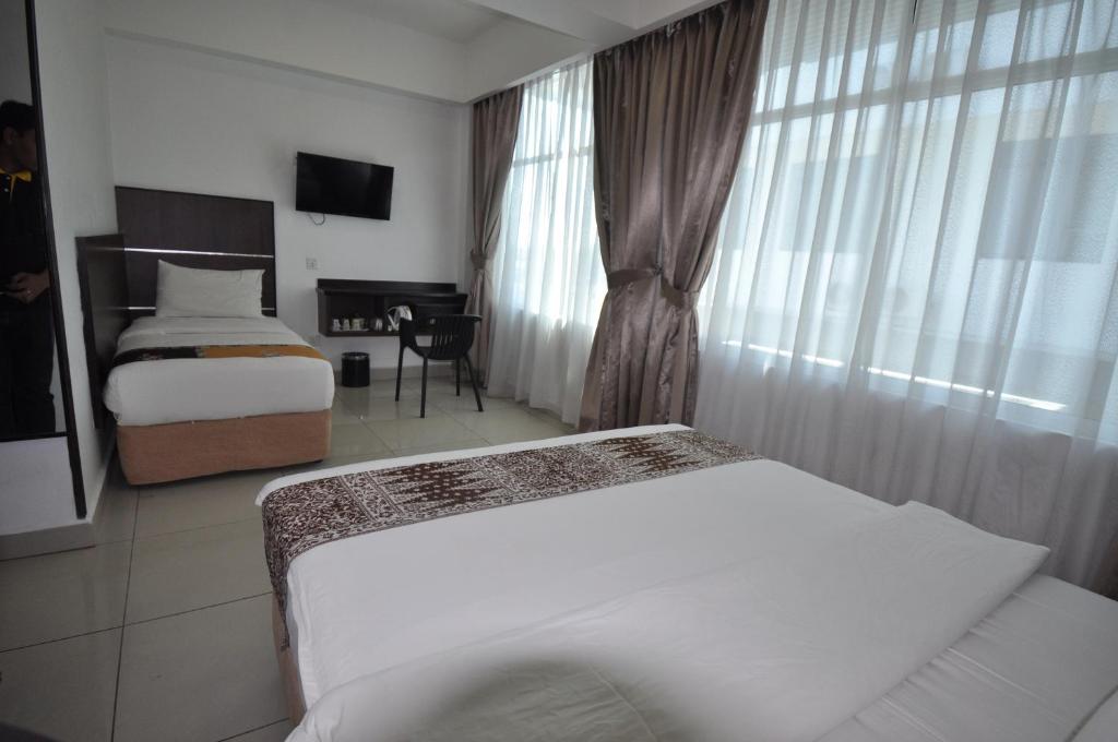 Postel nebo postele na pokoji v ubytování Sipadan Inn 3