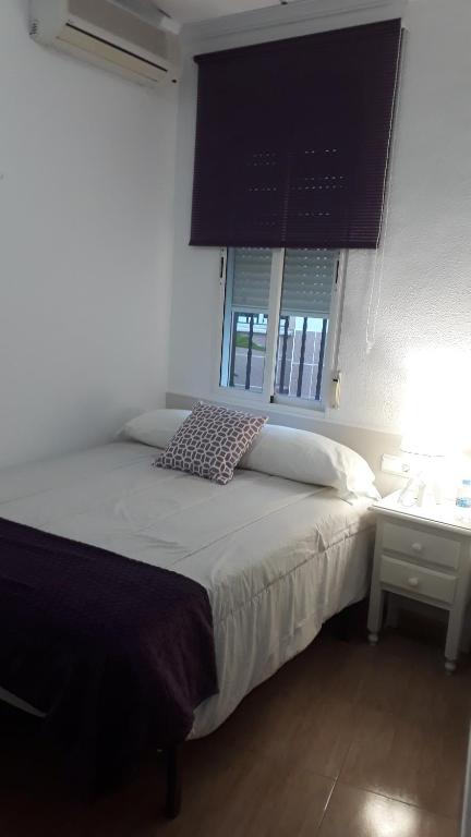 sypialnia z łóżkiem, biurkiem i oknem w obiekcie Hostal VILLA CARBULA w mieście Almodóvar del Río