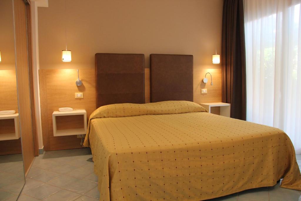 Postel nebo postele na pokoji v ubytování Baia del Godano Resort & Spa