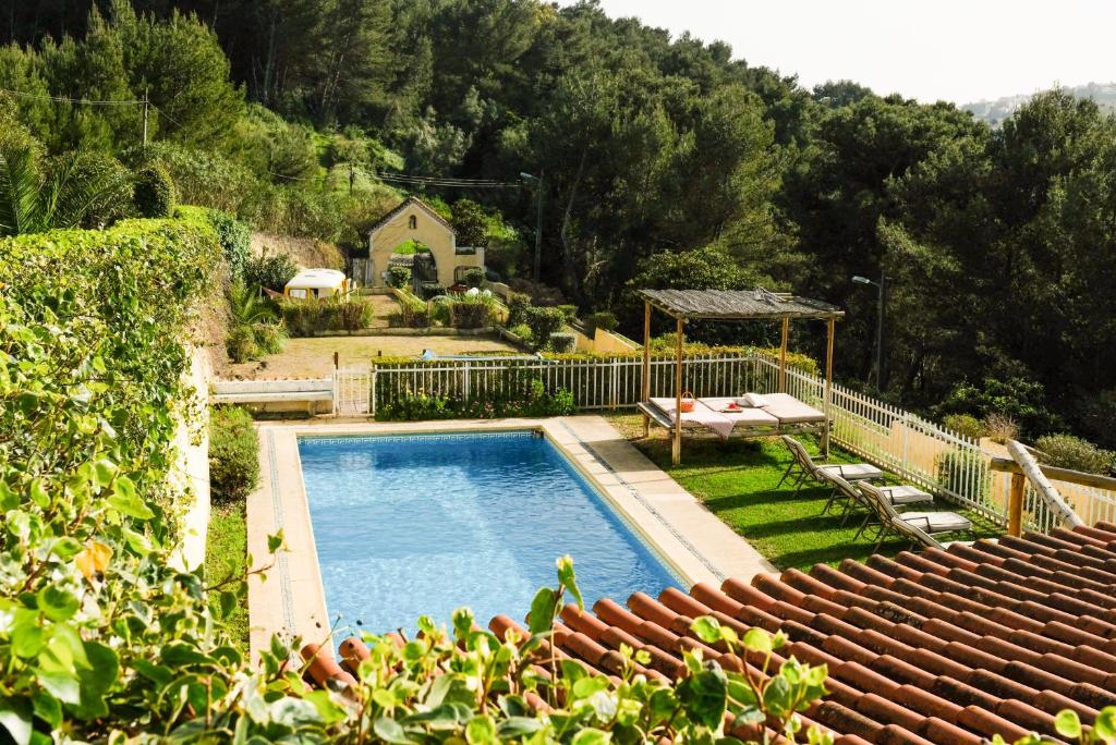 a swimming pool in a yard next to a house at Lisbon Country Villa in Oeiras