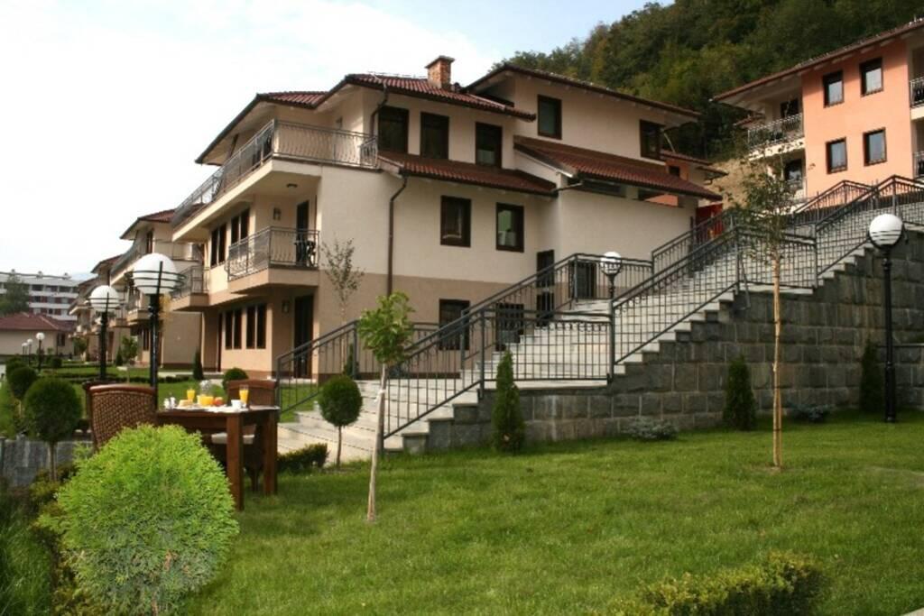 a large house with stairs in a yard at Apartment Aquareumal Fojnica in Fojnica