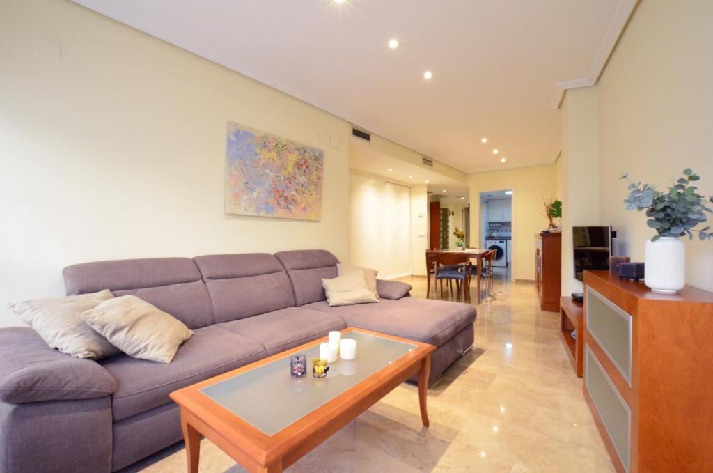 a living room with a couch and a table at City Center Apartment in Valencia