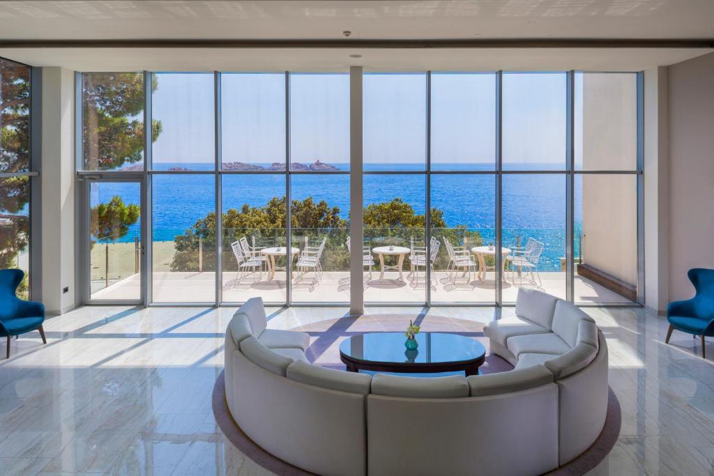 a living room with a couch and a view of the ocean at Royal Neptun Hotel in Dubrovnik