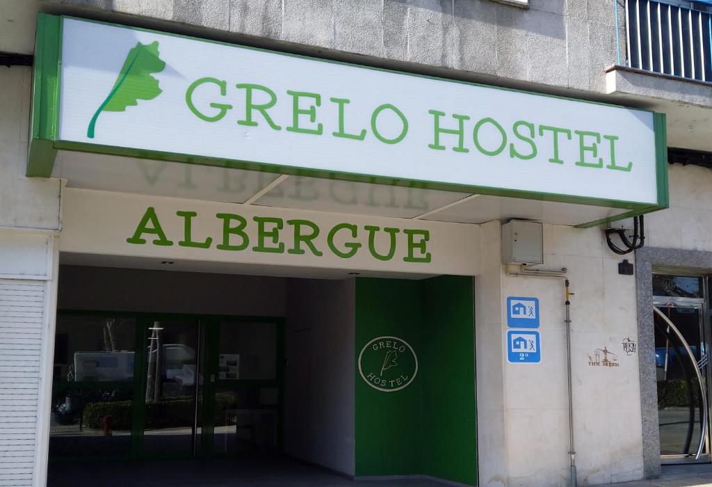 a sign for aza assisted alberge on a building at Grelo Hostel in Ourense