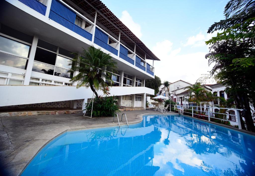 a large swimming pool in front of a building at Grande Hotel de Ouro Preto in Ouro Preto