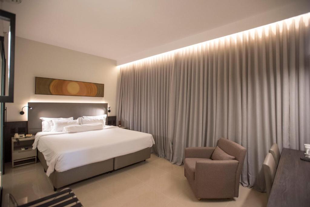 Cama ou camas em um quarto em Royal Boutique Savassi Hotel