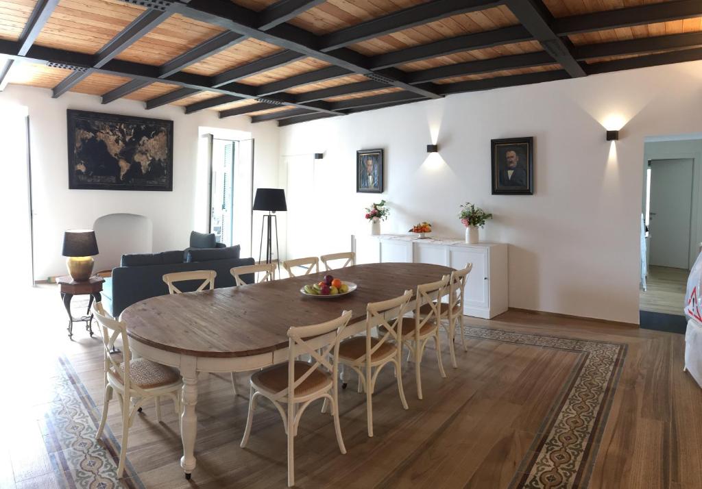 a dining room and living room with a table and chairs at Agriturismo SanCristoforo in Levanto