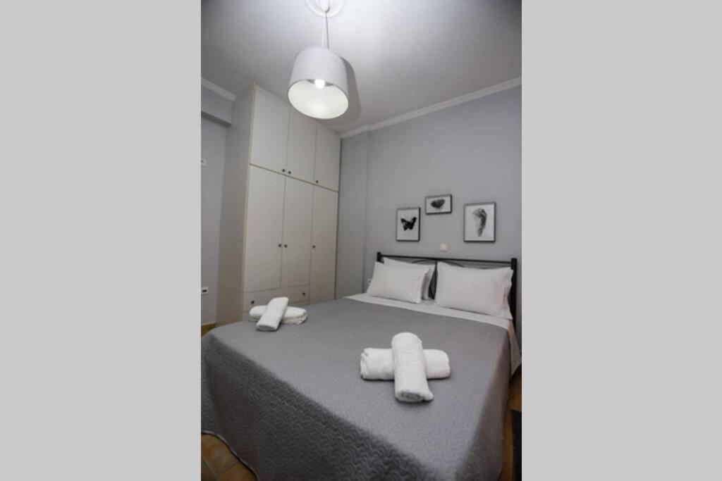 a bedroom with a bed with two towels on it at D&C APARTMENT2 in Kontokali