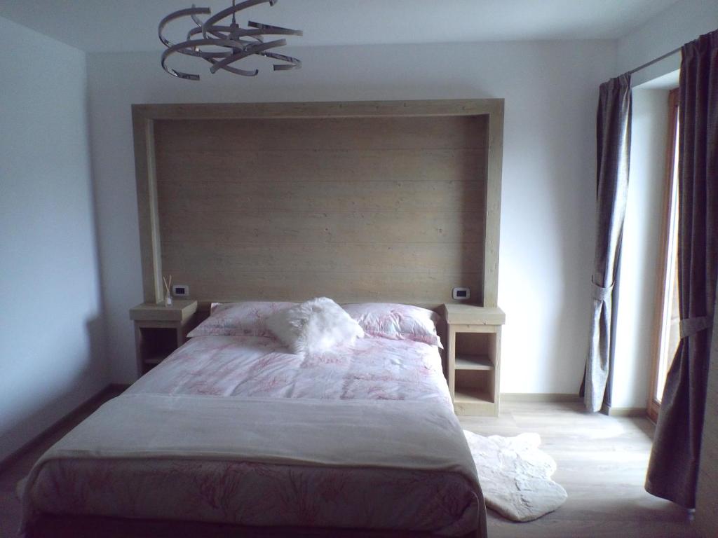 Postel nebo postele na pokoji v ubytování B&B antico tabià dolomitico