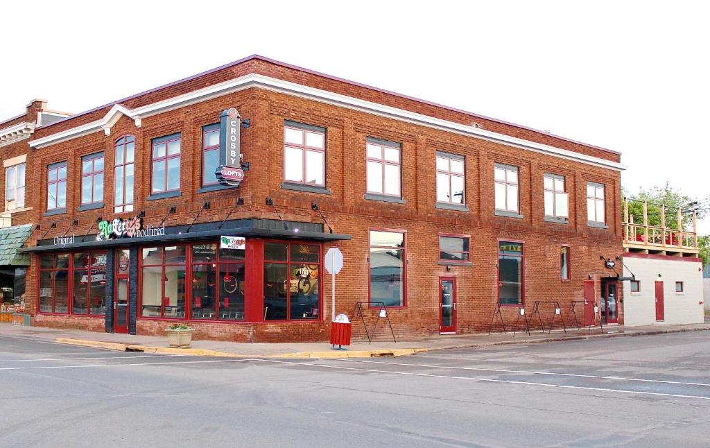 a brick building on the corner of a street at Crosby Lofts in Crosby