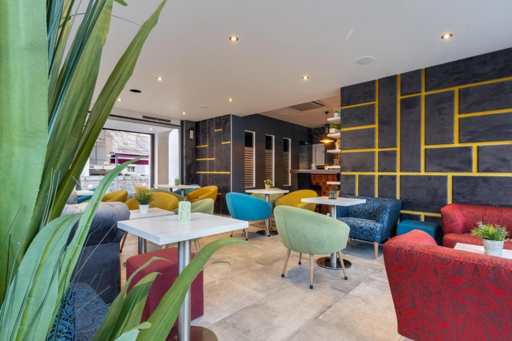 a restaurant with colorful chairs and tables and chairs at Hotel Sky in Zadar
