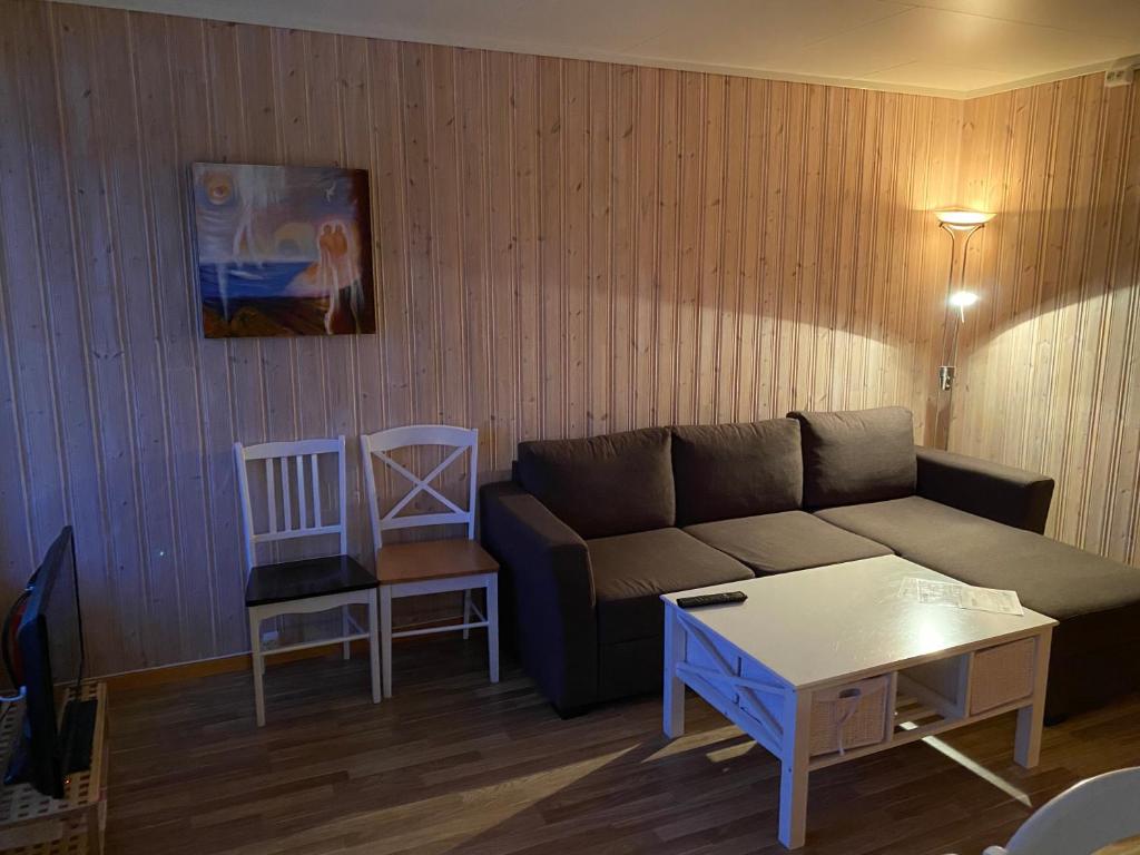a living room with a couch and a table at IMA Tursenter in Oteren
