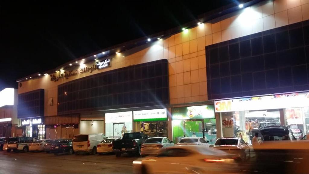 a building with cars parked outside of it at night at Nozol Mena 109 by Al Azmy in Riyadh