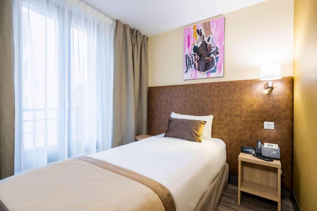 Postel nebo postele na pokoji v ubytování Quality Hotel Toulouse Centre
