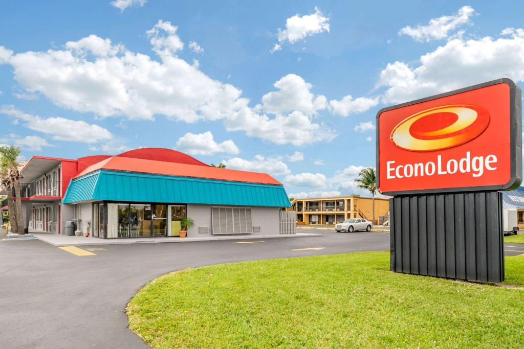 a sign in front of a building with a restaurant at Econo Lodge North in North Fort Myers