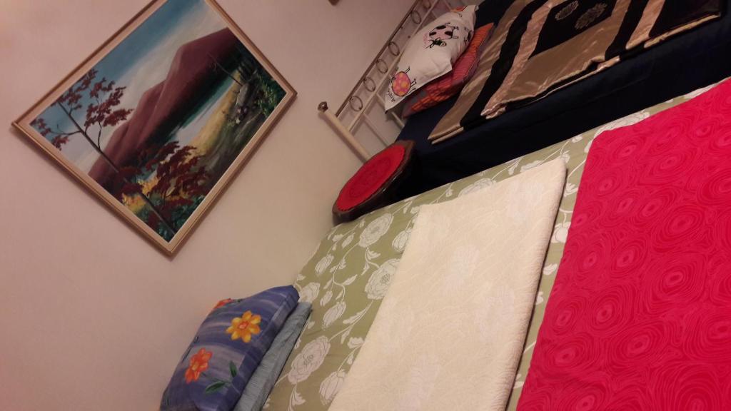 een slaapkamer met een bed en foto's aan de muur bij Next to City Center, Beside Bus and Train Station, Safe and Cozy Place in Oulu