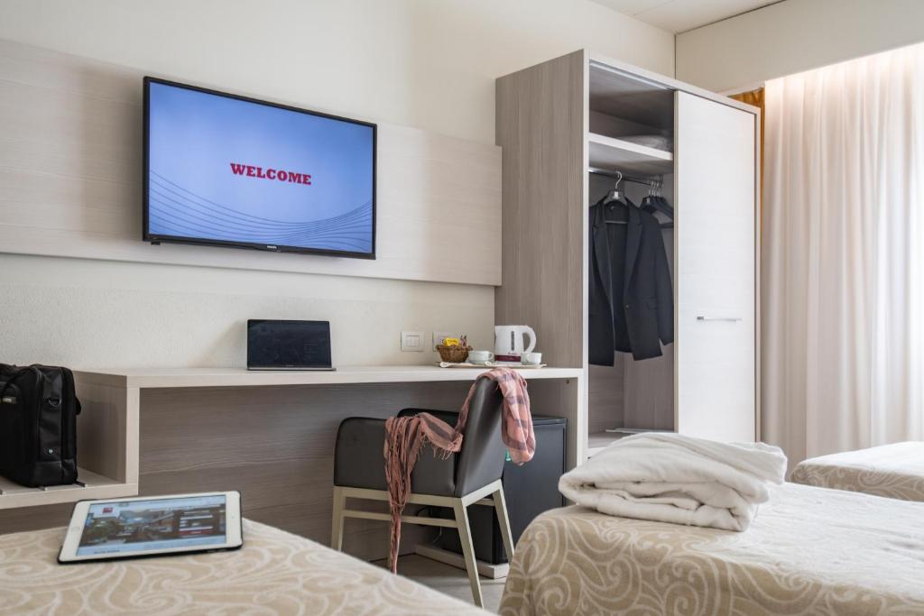 Postel nebo postele na pokoji v ubytování Alfa Fiera Hotel