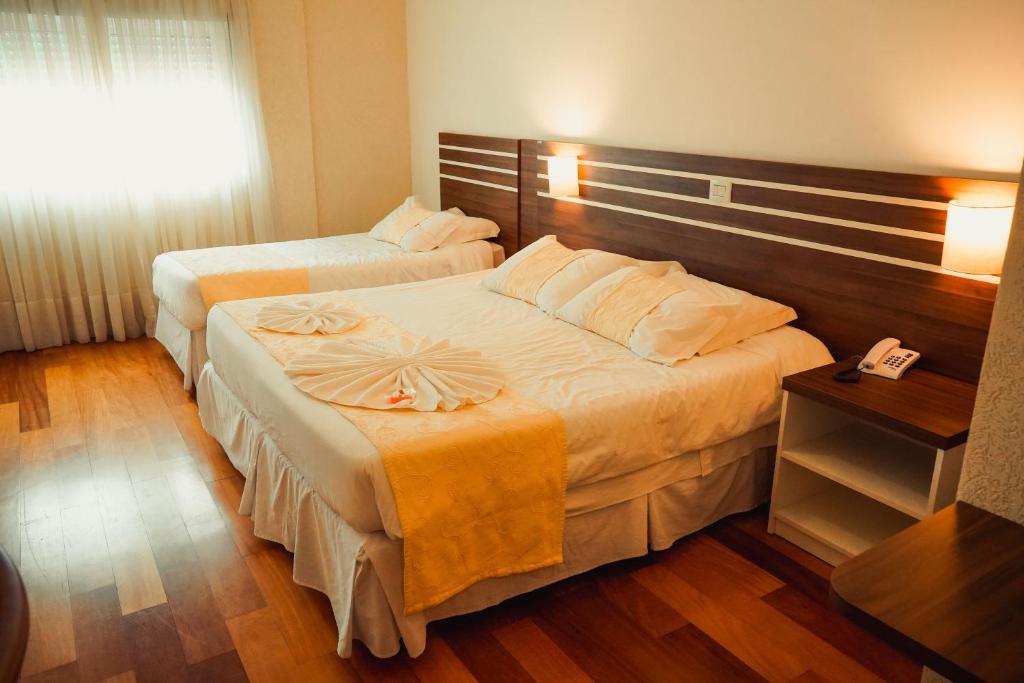 Postel nebo postele na pokoji v ubytování Hotel Imperial de Quatro Barras