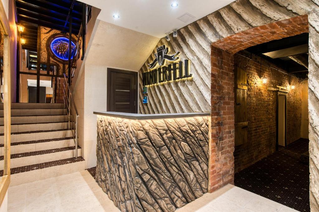 a lobby of a restaurant with a stone wall at Winterfell on Novokuznetskaya in Moscow
