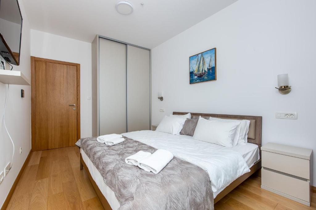 Un pat sau paturi într-o cameră la Apartments LORA in Apart-hotel