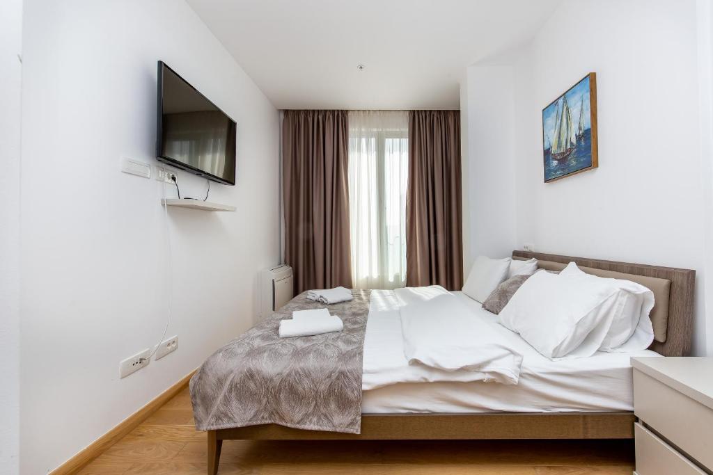 Un pat sau paturi într-o cameră la Apartments LORA in Apart-hotel