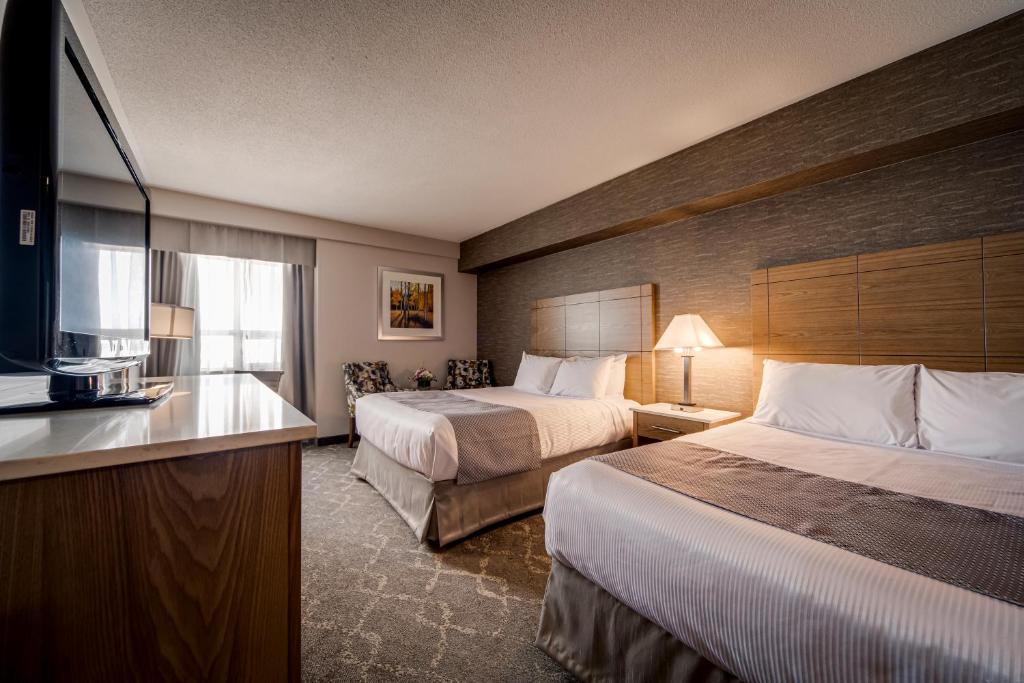 Voodi või voodid majutusasutuse Monte Carlo Inn Vaughan Suites toas
