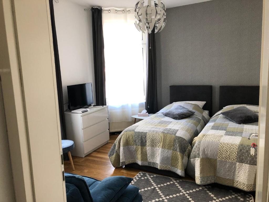 a bedroom with two beds and a mirror at Homeway Frankfurt in Frankfurt