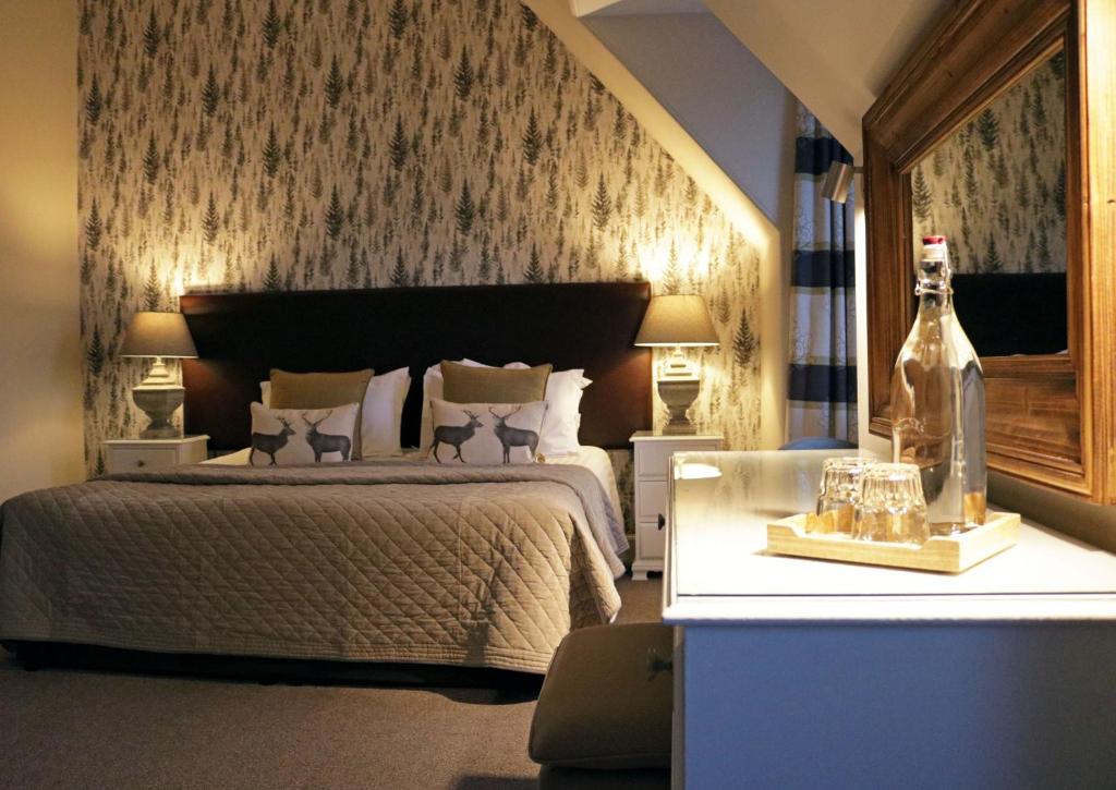 a bedroom with a bed and a bottle of wine at No12 Hotel in North Berwick